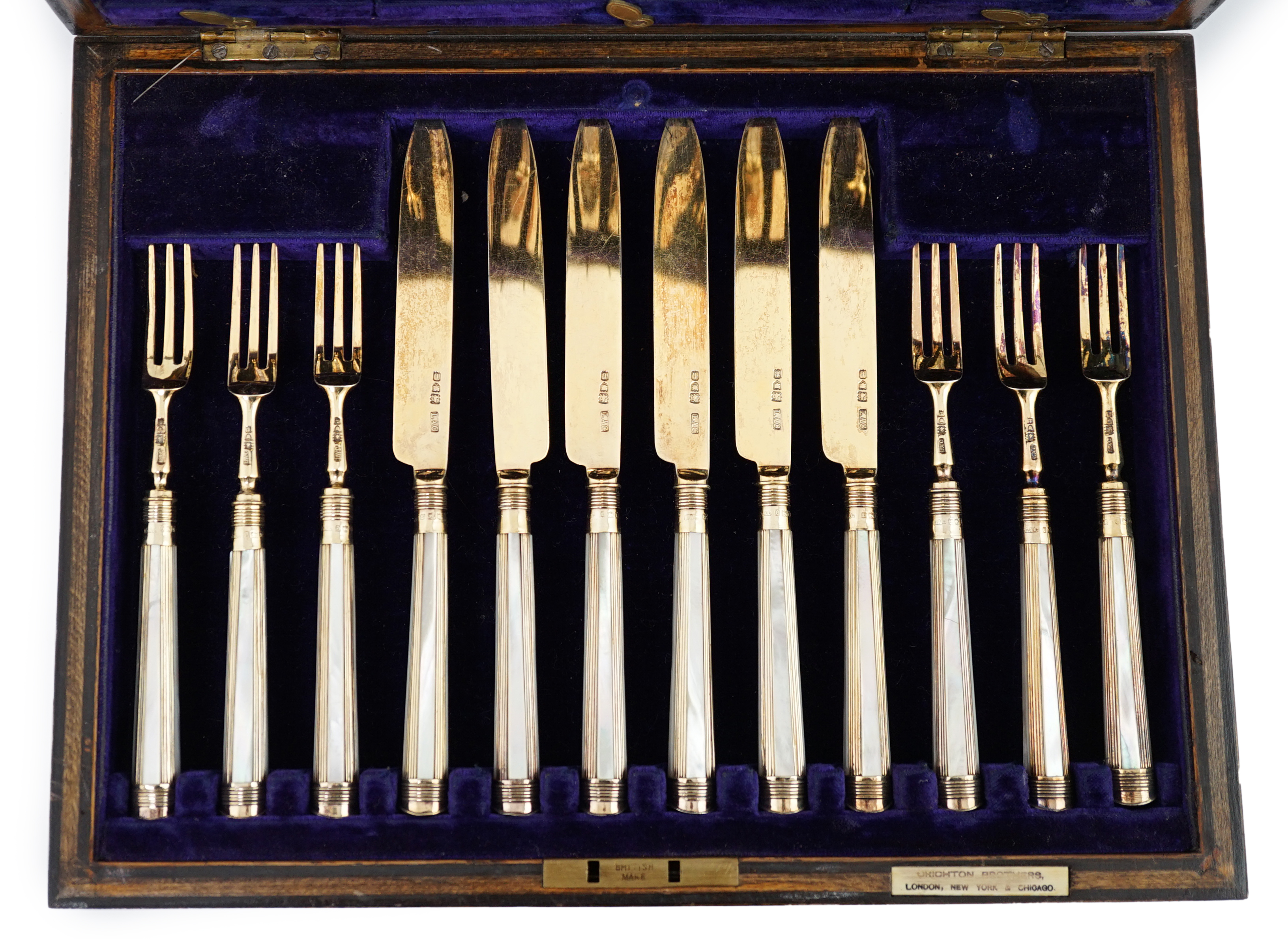 A cased set of twelve pairs of George V silver gilt dessert eaters by Crichton Brothers